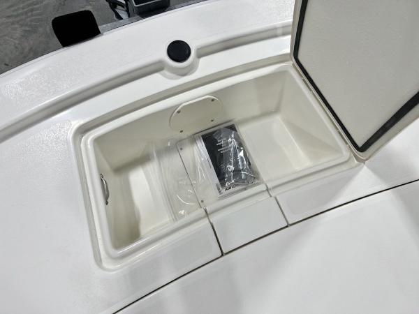 Slide: The Image of 2023 Mako Pro Skiff 13 CC storage compartment with manual. - 7