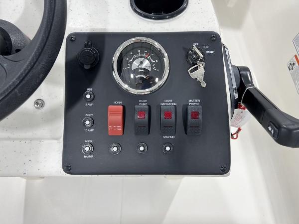 Slide: The Image of Control panel of a 2023 Mako Pro Skiff 13 CC boat with ignition and switches. - 8