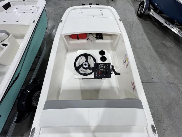Slide: The Image of 2023 Mako Pro Skiff 13 CC boat interior with steering console and seating. - 9