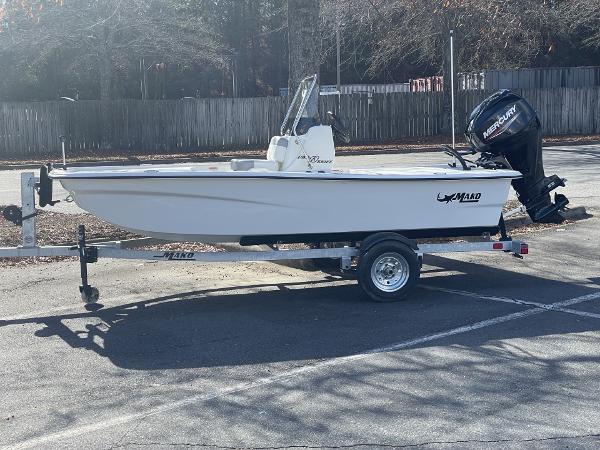 Slide: The Image of 2024 Mako Pro Skiff 13 CC boat on trailer in parking lot. - 0