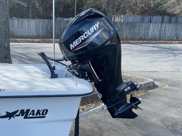Slide: The Image of 2024 Mako Pro Skiff 13 CC with Mercury outboard motor in a parking lot. - 3