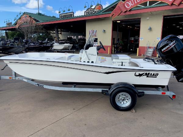 Slide: The Image of 2024 Mako Pro Skiff 15 CC boat on trailer outside dealership. - 1