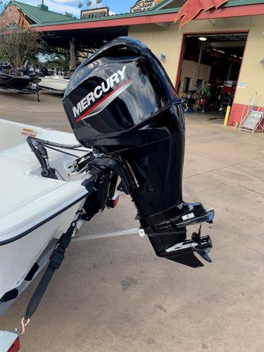 Slide: The Image of 2024 Mako Pro Skiff 15 CC with Mercury outboard motor at a dealership. - 13