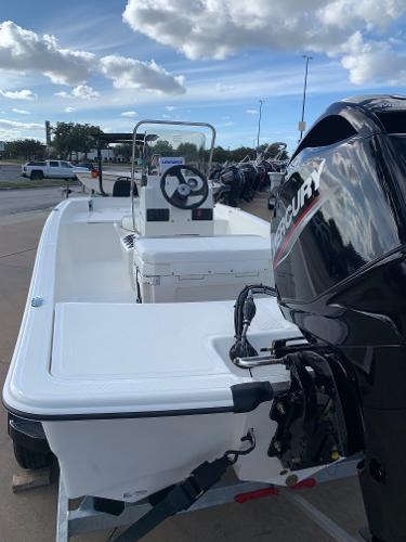 Slide: The Image of 2024 Mako Pro Skiff 15 CC boat with Mercury outboard motor. - 2