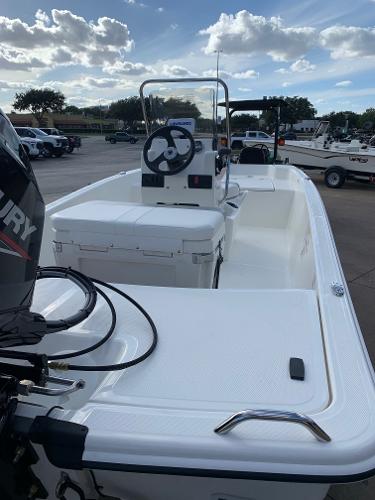 Slide: The Image of 2024 Mako Pro Skiff 15 CC boat with center console and Mercury outboard motor. - 3