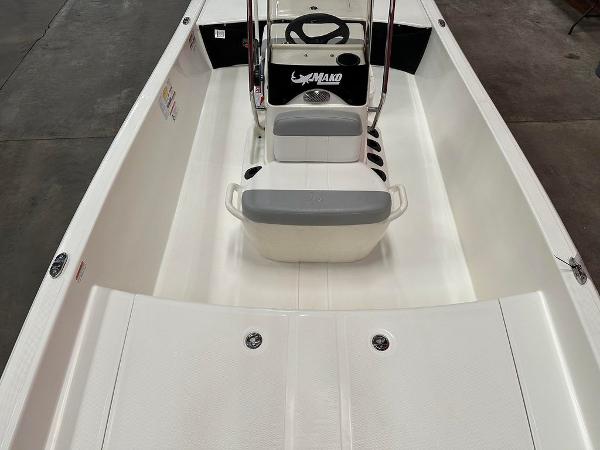 Slide: The Image of 2023 Mako Pro Skiff 17 CC interior view, featuring seating and steering console. - 2