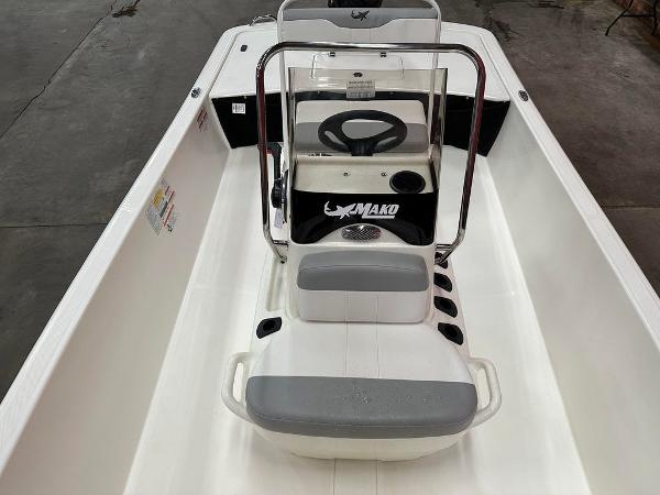 Slide: The Image of 2023 Mako Pro Skiff 17 CC center console boat interior with steering wheel and seating. - 3