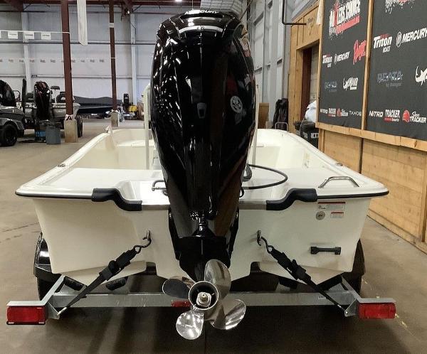 Slide: The Image of 2023 Mako Pro Skiff 17 CC boat on trailer, rear view in warehouse. - 5