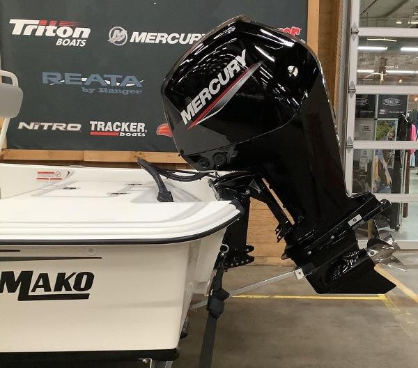 Slide: The Image of 2023 Mako Pro Skiff 17 CC with Mercury outboard motor in showroom. - 7