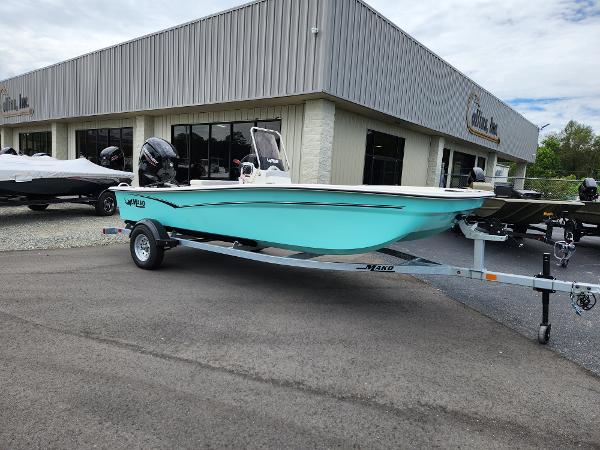 Slide: The Image of 2024 Mako Pro Skiff 17 CC boat on trailer outside dealership. - 1