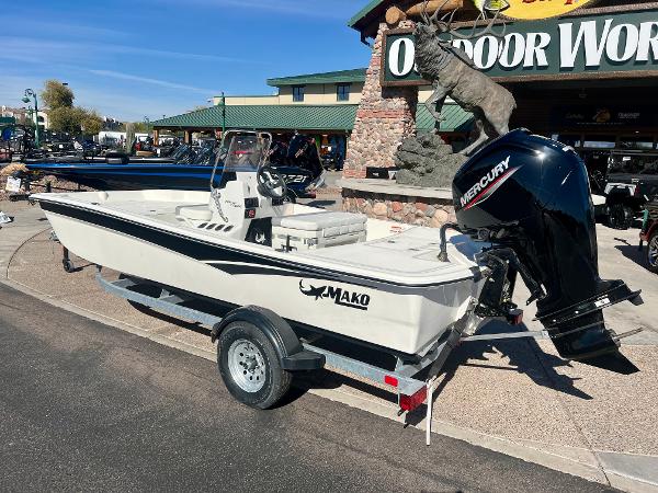 Slide: The Image of 2024 Mako Pro Skiff 17 CC boat on trailer outside Outdoor World. - 2