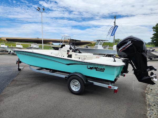 Slide: The Image of 2024 Mako Pro Skiff 17 CC boat with Mercury outboard motor on trailer. - 3