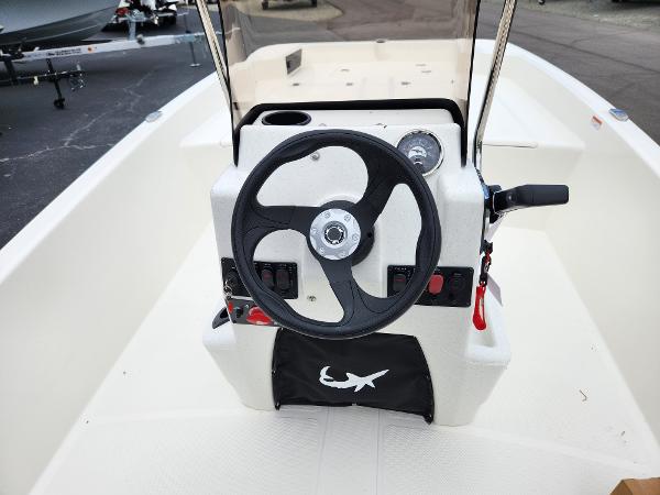 Slide: The Image of 2024 Mako Pro Skiff 17 CC center console with steering wheel and controls. - 9