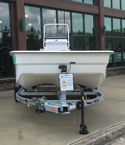 Slide: The Image of 2023 Mako Pro Skiff 19 CC boat on trailer outside showroom. - 0