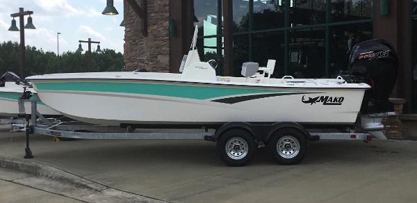 Slide: The Image of 2023 Mako Pro Skiff 19 CC on trailer outside building. - 1