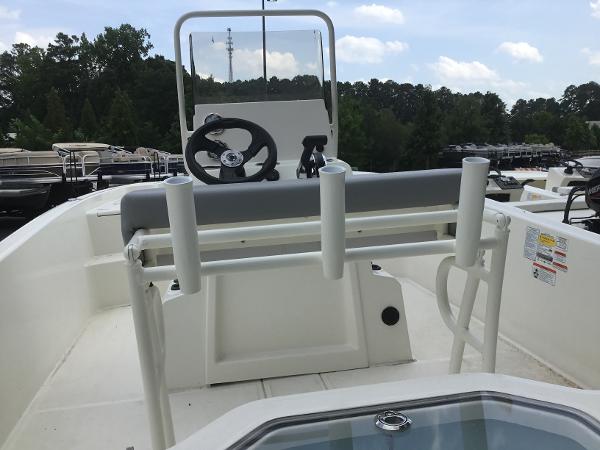 Slide: The Image of 2023 Mako Pro Skiff 19 CC center console boat with rod holders and steering wheel. - 3