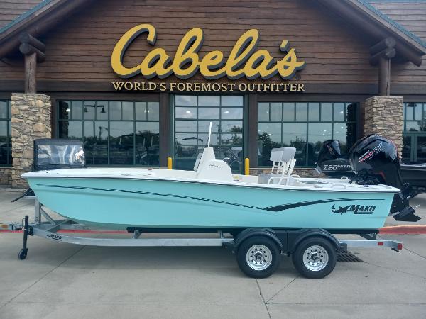 Slide: The Image of 2024 Mako Pro Skiff 19 CC boat on trailer outside Cabela's store. - 0