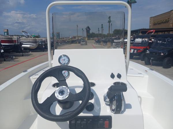 Slide: The Image of 2024 Mako Pro Skiff 19 CC center console with steering wheel and controls. - 2