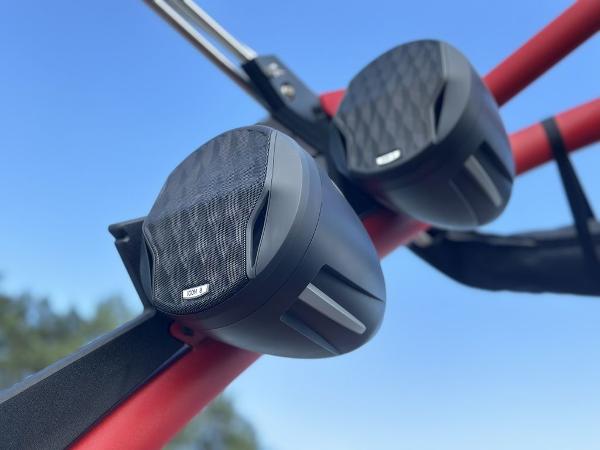 Slide: The Image of Speakers mounted on a red frame of a 2025 Malibu 23 LSV boat. - 1