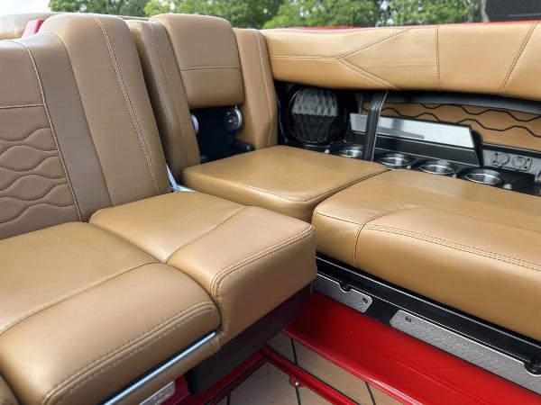 Slide: The Image of Luxurious tan leather seating in the 2025 Malibu 23 LSV boat interior. - 10