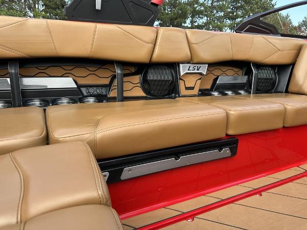 Slide: The Image of 2025 Malibu 23 LSV boat interior with tan leather seats and modern design elements. - 11