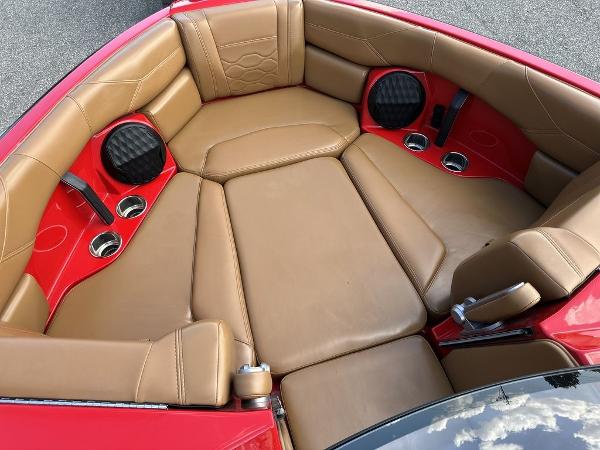 Slide: The Image of 2025 Malibu 23 LSV boat interior with tan leather seats and red accents. - 20