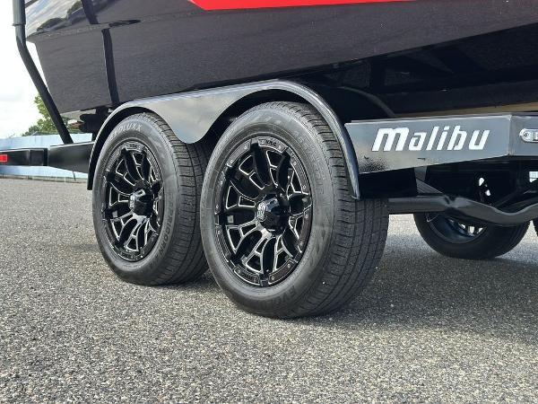 Slide: The Image of 2025 Malibu 23 LSV trailer with black alloy wheels on asphalt. - 6