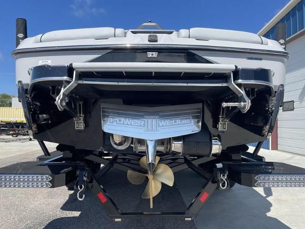 Slide: The Image of 2023 Malibu 24 MXZ boat stern view with propeller and Power Wedge III. - 6