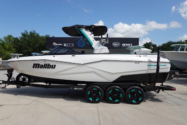 Slide: The Image of 2023 Malibu 25 LSV boat on a trailer, side view. - 0