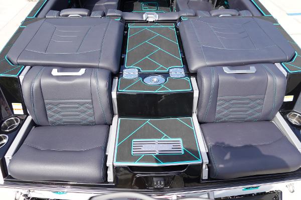 Slide: The Image of 2023 Malibu 25 LSV boat interior with black and teal seating. - 13