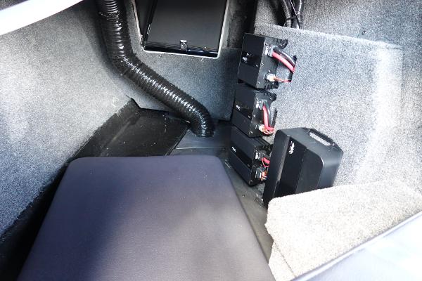 Slide: The Image of 2023 Malibu 25 LSV interior storage compartment with battery setup. - 33