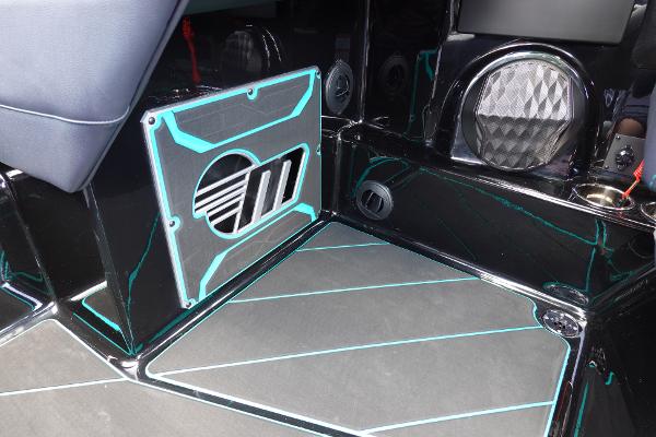 Slide: The Image of 2023 Malibu 25 LSV boat interior with custom speaker and flooring. - 34