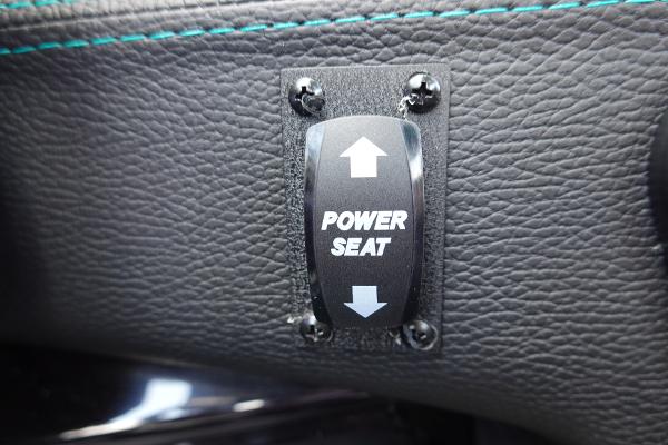 Slide: The Image of 2023 Malibu 25 LSV power seat adjustment switch on black leather. - 35
