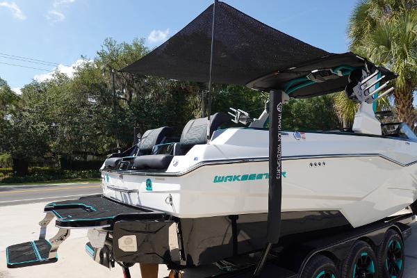 Slide: The Image of 2023 Malibu 25 LSV boat with wakeboard tower and sunshade. - 41