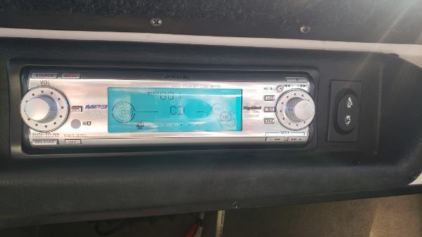 Slide: The Image of 1998 Malibu Sunsetter VLX boat stereo system with digital display and control knobs. - 11