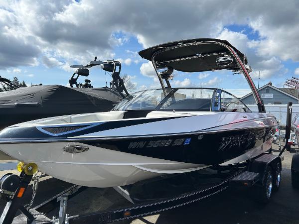 Slide: The Image of 2013 Malibu Wakesetter 20 VTX boat on trailer under cloudy sky. - 0