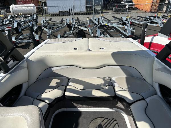 Slide: The Image of 2013 Malibu Wakesetter 20 VTX boat interior with gray seating and trailer background. - 14