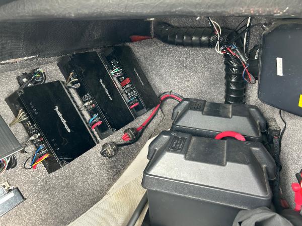 Slide: The Image of 2013 Malibu Wakesetter 20 VTX interior showing audio system and battery setup. - 21