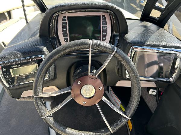 Slide: The Image of 2013 Malibu Wakesetter 20 VTX dashboard with steering wheel and digital displays. - 4