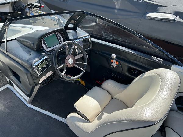 Slide: The Image of 2013 Malibu Wakesetter 20 VTX boat interior with steering wheel and dashboard controls. - 5