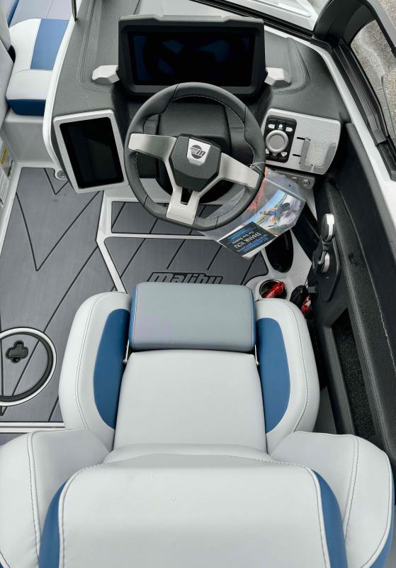 Slide: The Image of 2024 Malibu 20 VTX boat cockpit with steering wheel and modern dashboard. - 10