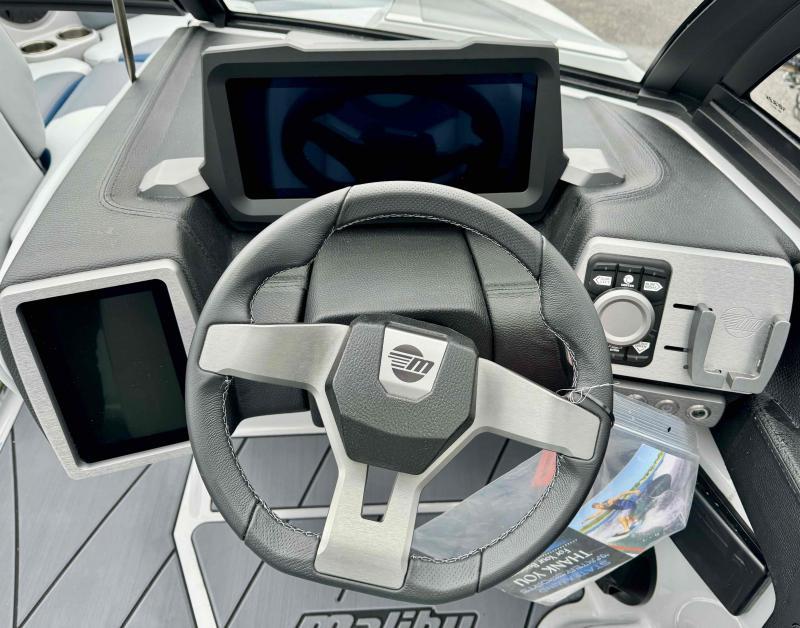 Slide: The Image of 2024 Malibu 20 VTX boat dashboard with steering wheel and digital displays. - 11