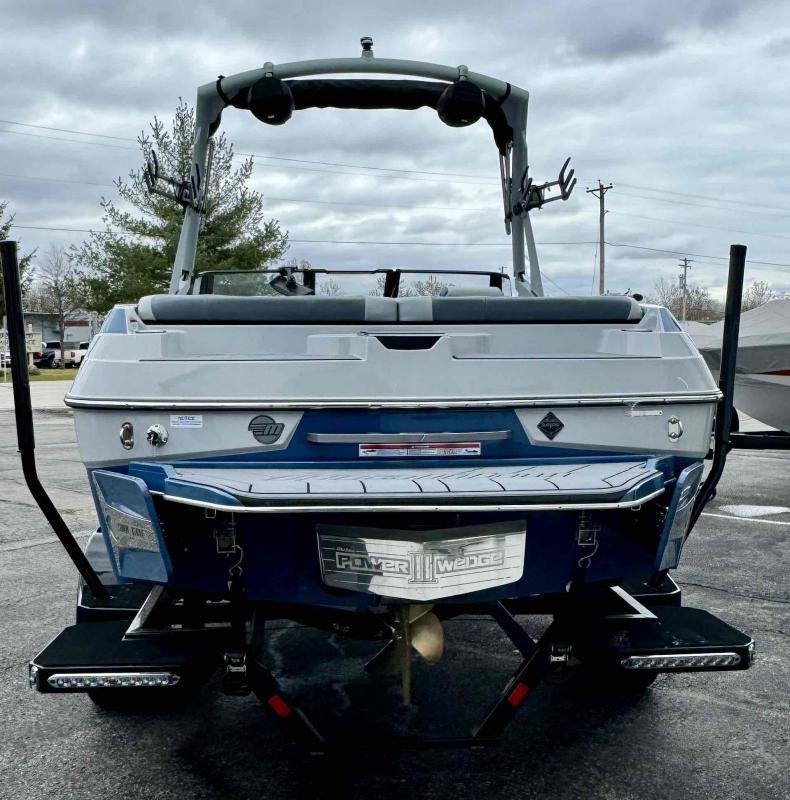 Slide: The Image of 2024 Malibu 20 VTX boat rear view with Power Wedge III on a cloudy day. - 14