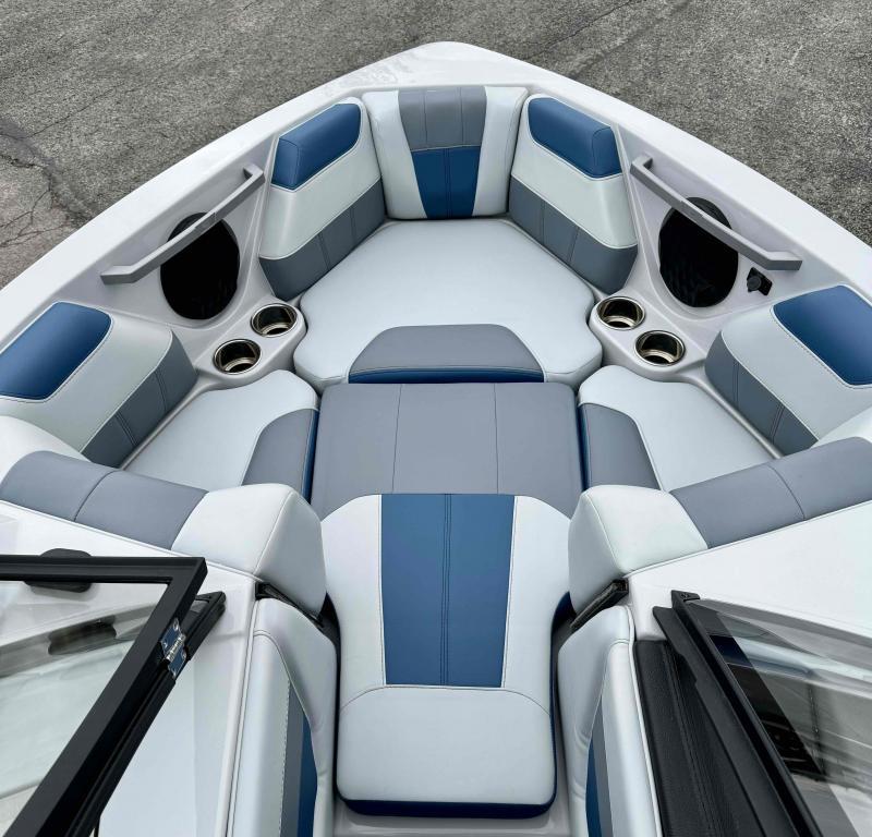 Slide: The Image of 2024 Malibu 20 VTX boat interior with blue and gray seating. - 9