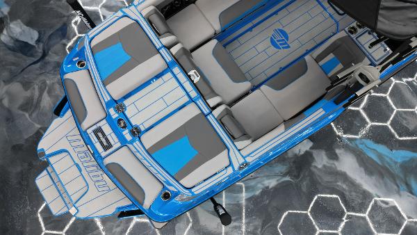 Slide: The Image of 2021 Malibu Wakesetter 24 MXZ boat with blue and gray interior on hexagonal water pattern. - 12
