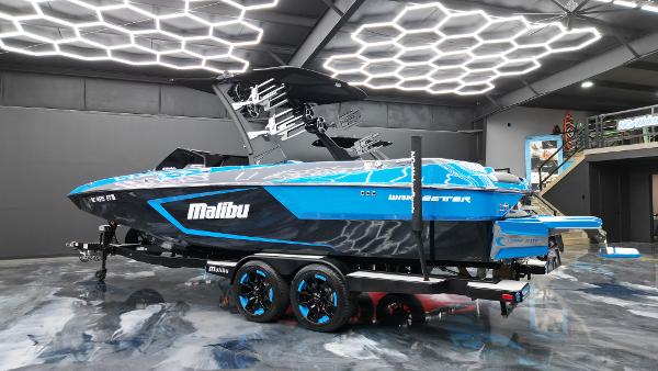 Slide: The Image of 2021 Malibu Wakesetter 24 MXZ boat in showroom with modern lighting. - 5