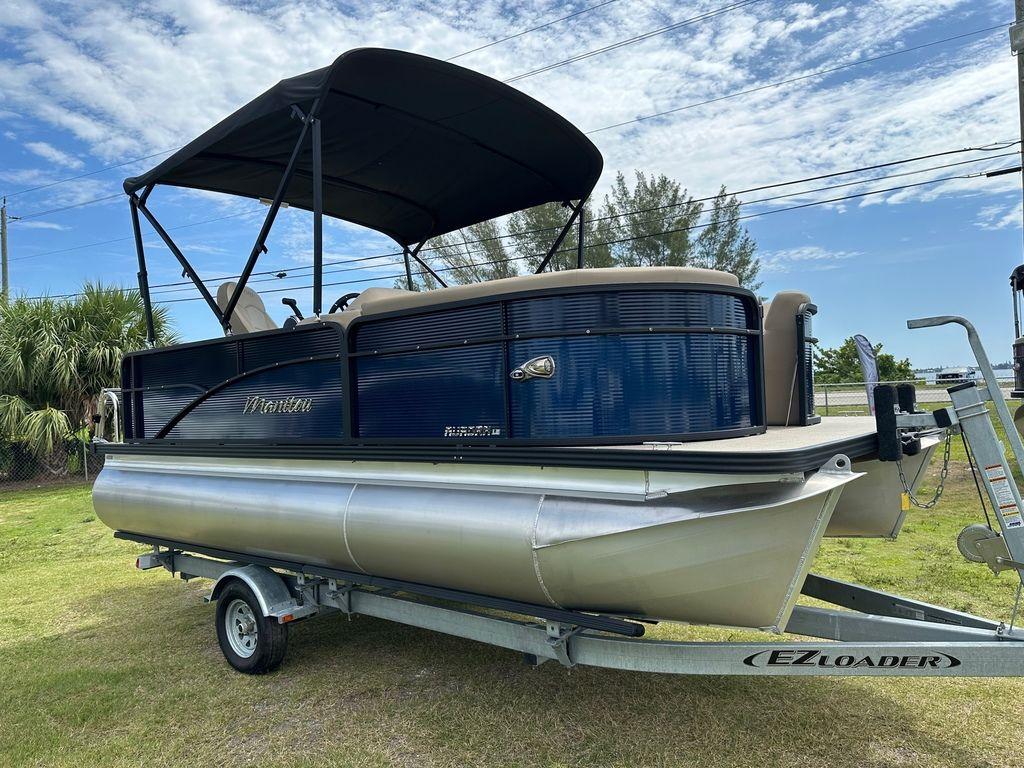 Slide: The Image of 2022 Manitou 18 Aurora LE Standard Twin Tube pontoon boat on EZ Loader trailer. - 1