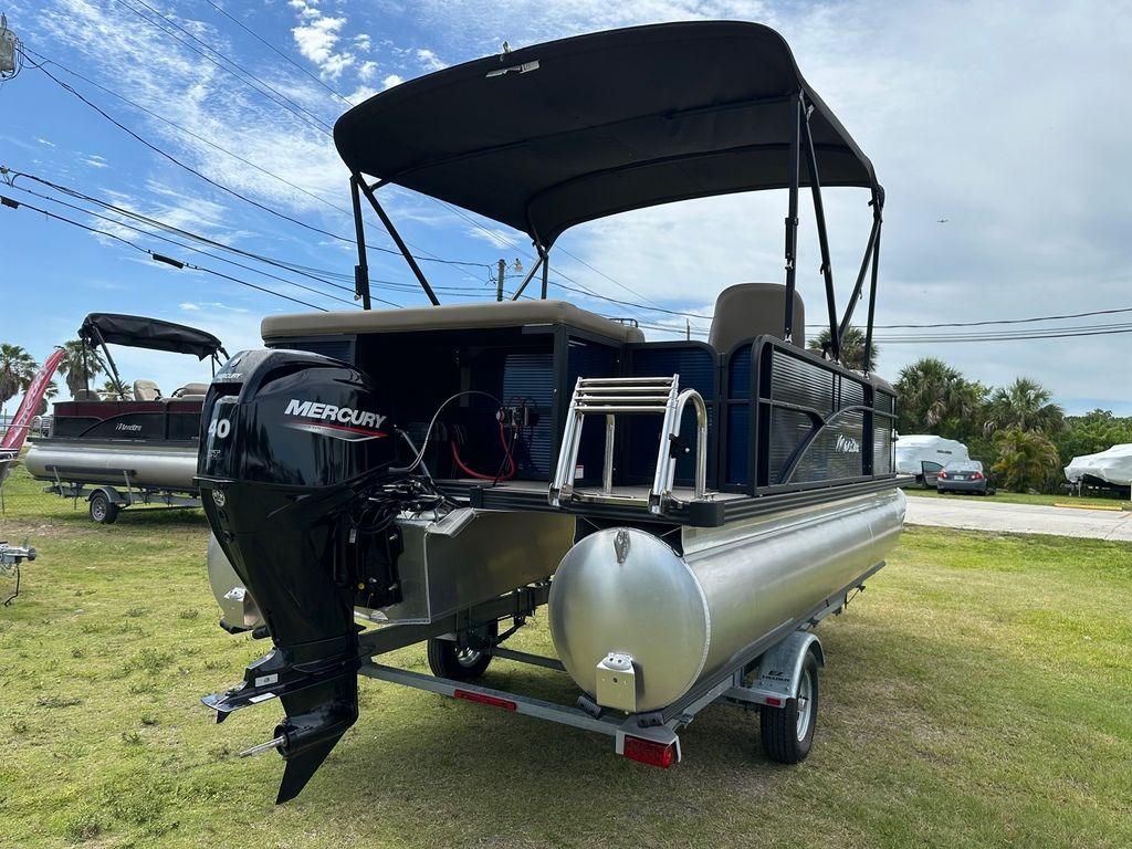 Slide: The Image of 2022 Manitou 18 Aurora LE Standard Twin Tube pontoon boat with Mercury 40 engine. - 11