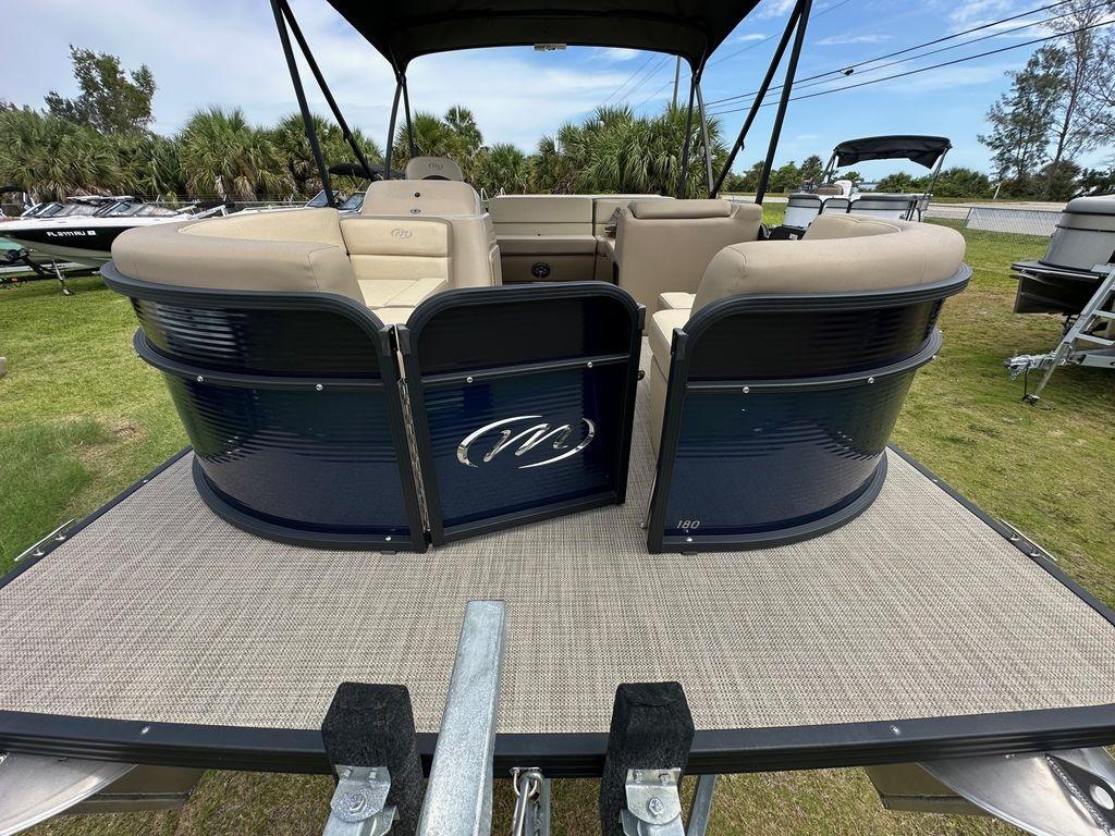 Slide: The Image of 2022 Manitou 18 Aurora LE Standard Twin Tube pontoon boat, rear view on trailer. - 12