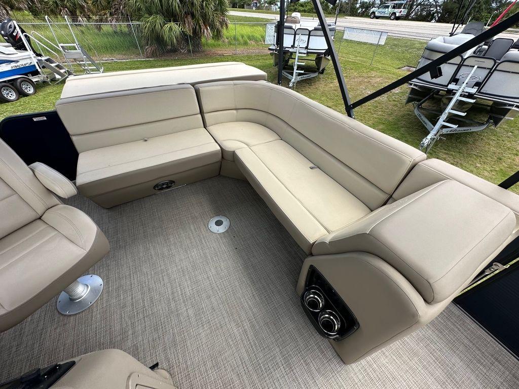 Slide: The Image of 2022 Manitou 18 Aurora LE Standard Twin Tube boat interior with beige seating. - 14